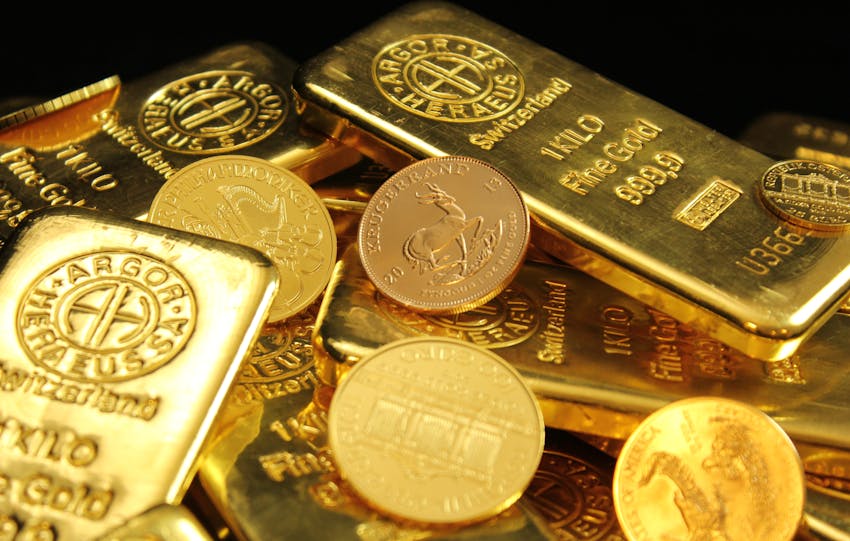 A detailed image of gold bars and coins symbolizing wealth and financial investment.