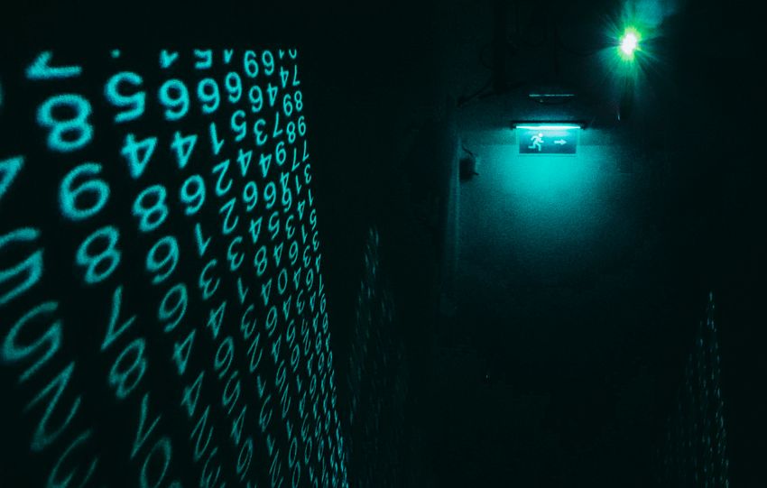 A dark hallway illuminated with neon digital number projections, creating a cyberpunk ambiance.
