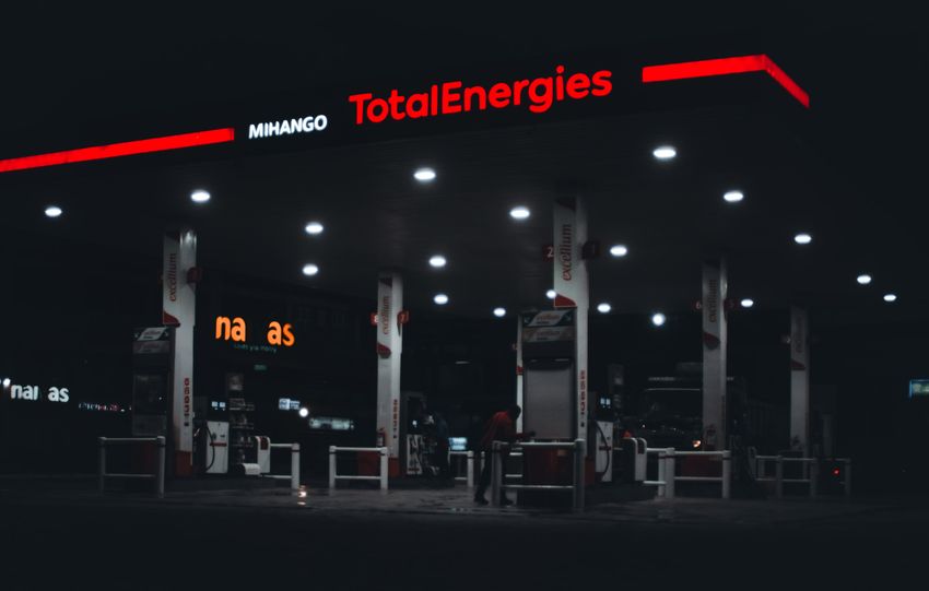 A dimly lit TotalEnergies gas station at night in Nairobi, Kenya, featuring prominent signage.
