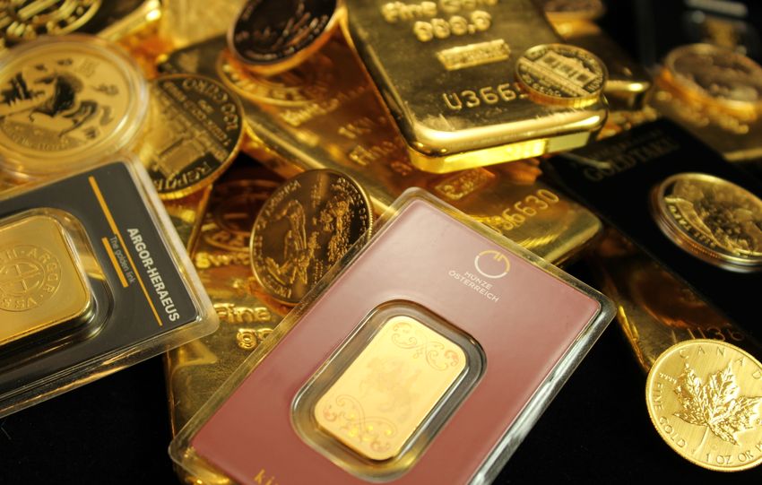 Detailed close-up of gold bars and coins symbolizing wealth and investment opportunities.