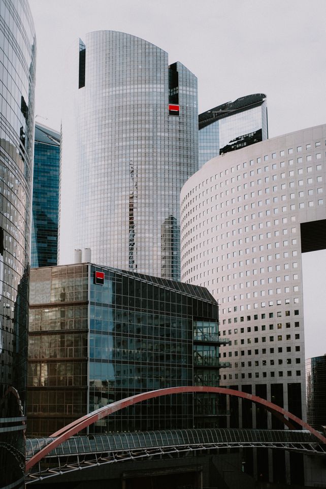 Detailed view of modern skyscrapers with a pedestrian walkway in an urban cityscape.