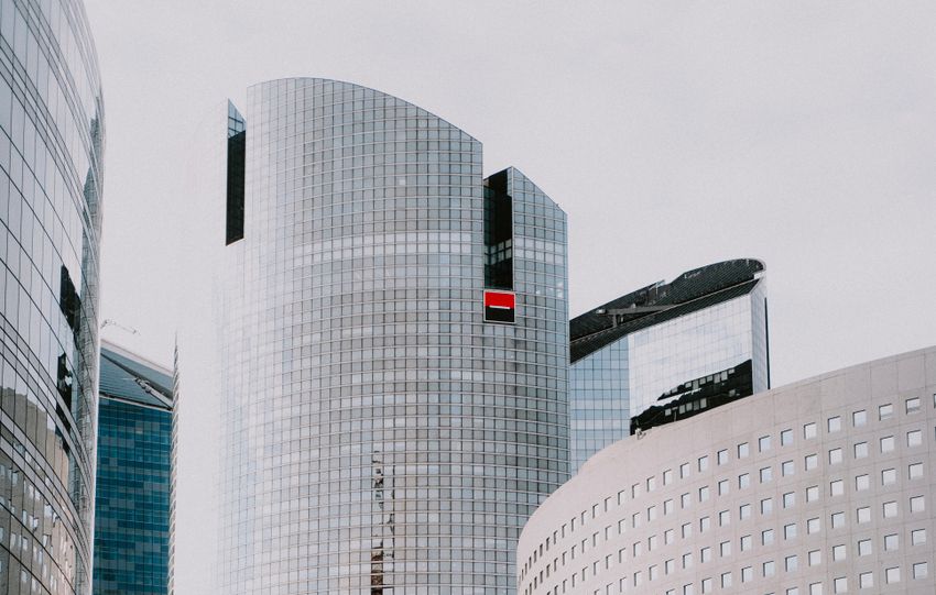 Detailed view of modern skyscrapers with a pedestrian walkway in an urban cityscape.