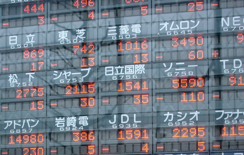 Digital display of stock market prices in Japan with kanji characters.