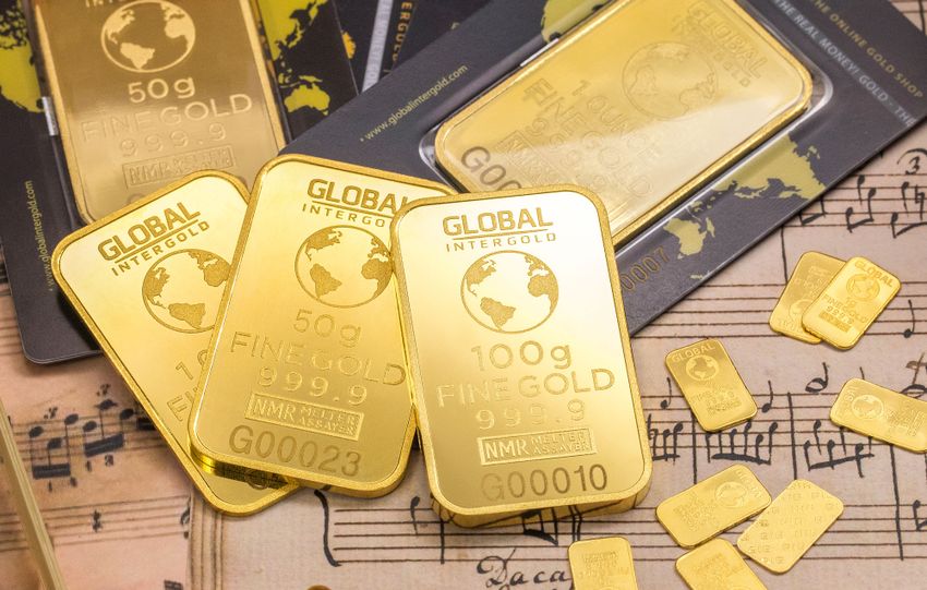 Gold bars stacked on sheet music, showcasing wealth and luxury with fine detail.