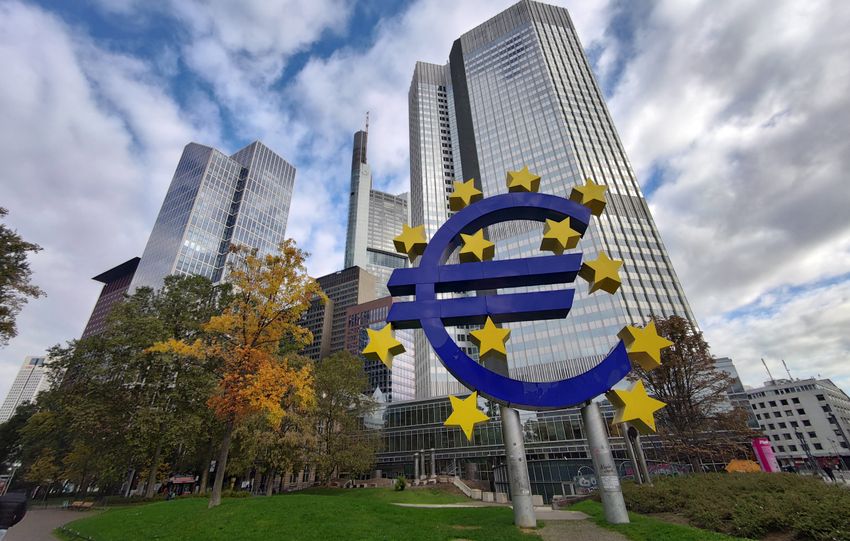Iconic Euro sculpture with modern skyscrapers in Frankfurt, Germany showcasing the financial district.
