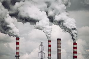 Smoke billows from factory chimneys in Konin, Poland, highlighting pollution and environmental impact.