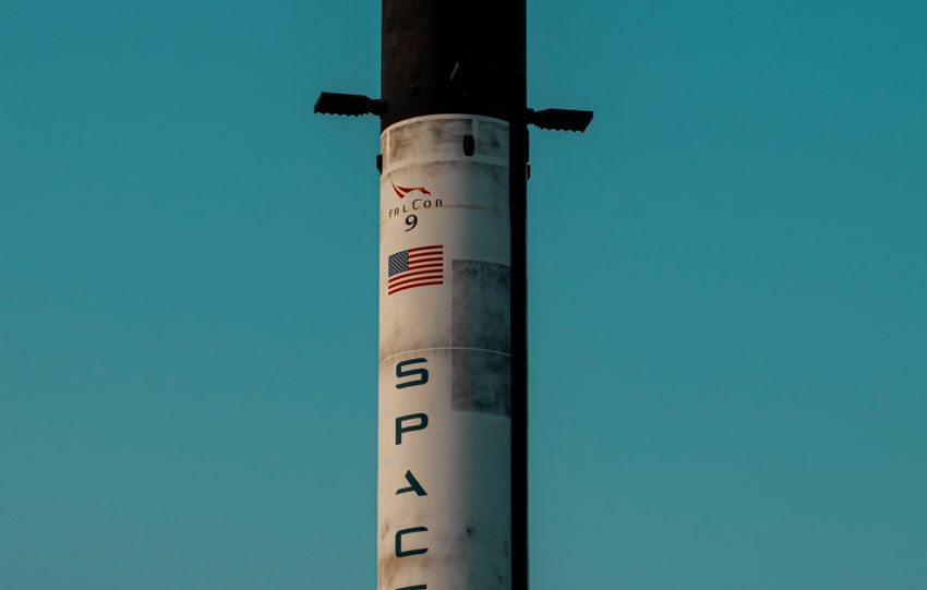 Vertical shot of a SpaceX rocket tower against a blue sky in Dubai, UAE.