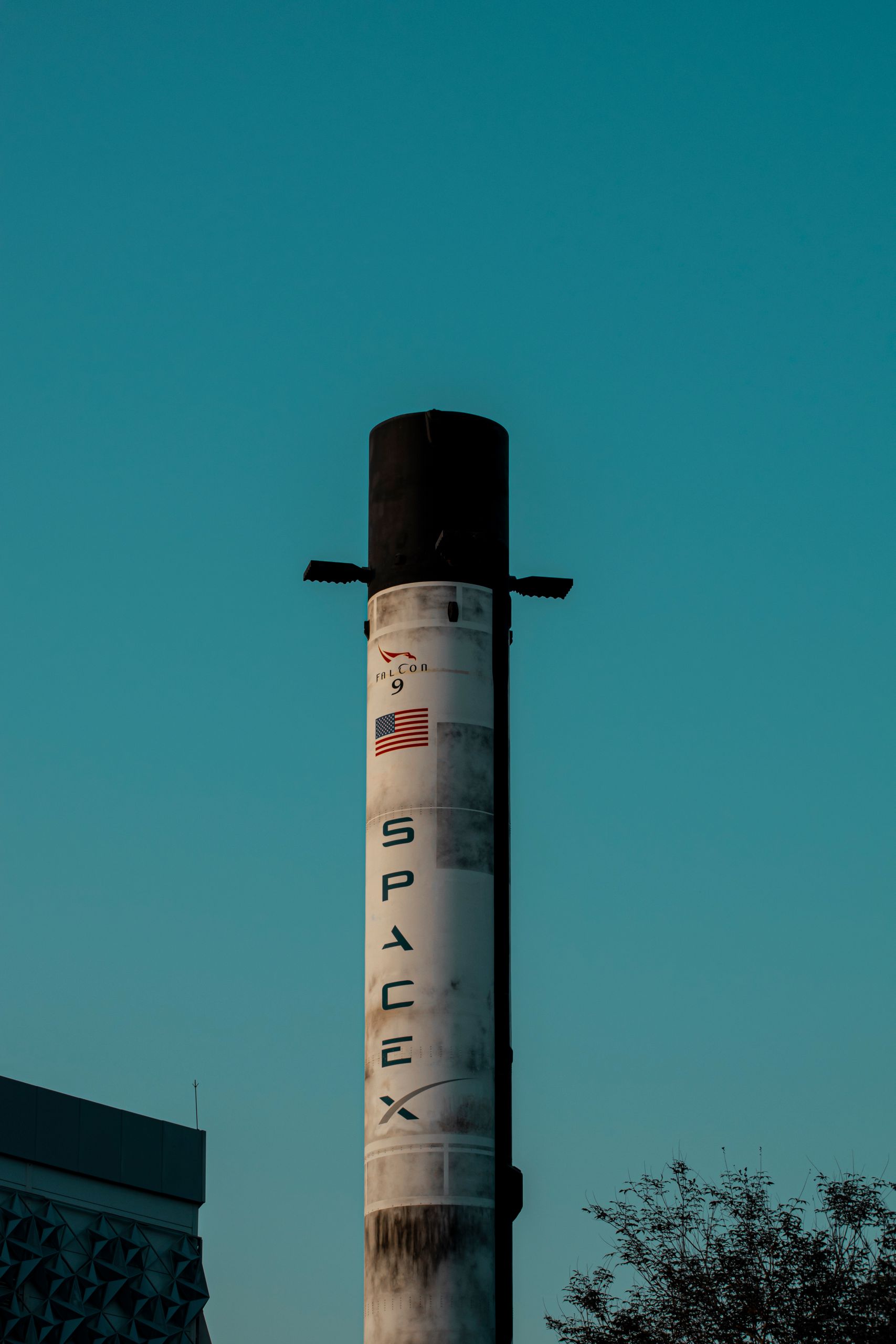 Vertical shot of a SpaceX rocket tower against a blue sky in Dubai, UAE.