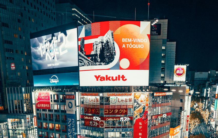 A bustling night scene of Shibuya Crossing, Tokyo, with vibrant city lights and crowds.