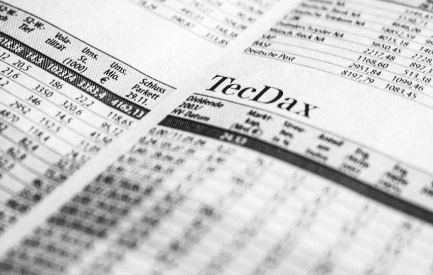 Close-up of a printed stock market report in black and white, highlighting stock prices.