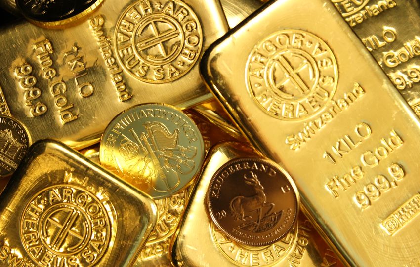 Close-up of shiny gold bars and coins, representing wealth and fortune.