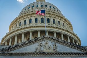 Close-up view of the iconic United States Capitol dome with American flag in Washington, D.C.