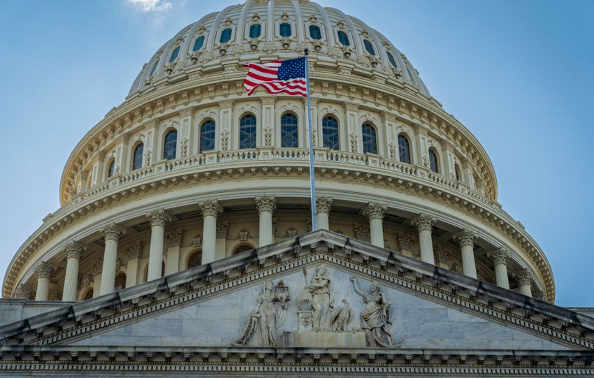 Close-up view of the iconic United States Capitol dome with American flag in Washington, D.C.