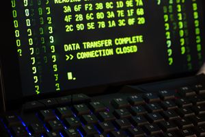Data transfer complete message displayed on a computer monitor with a keyboard underneath.