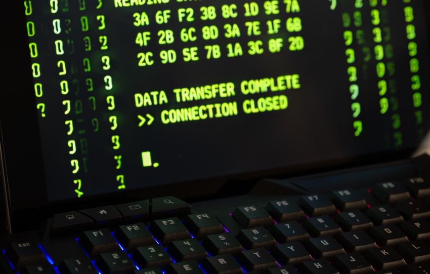 Data transfer complete message displayed on a computer monitor with a keyboard underneath.