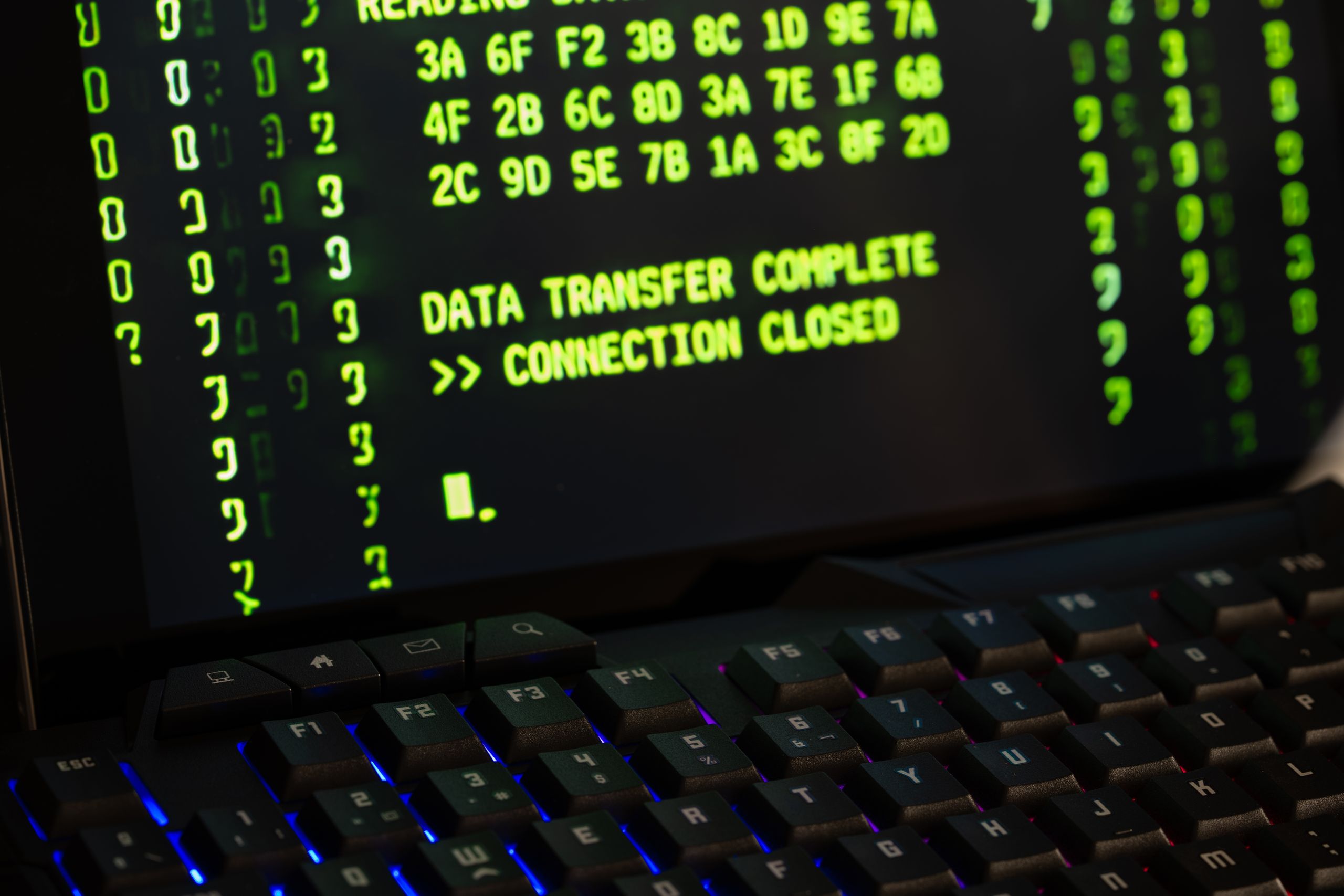 Data transfer complete message displayed on a computer monitor with a keyboard underneath.