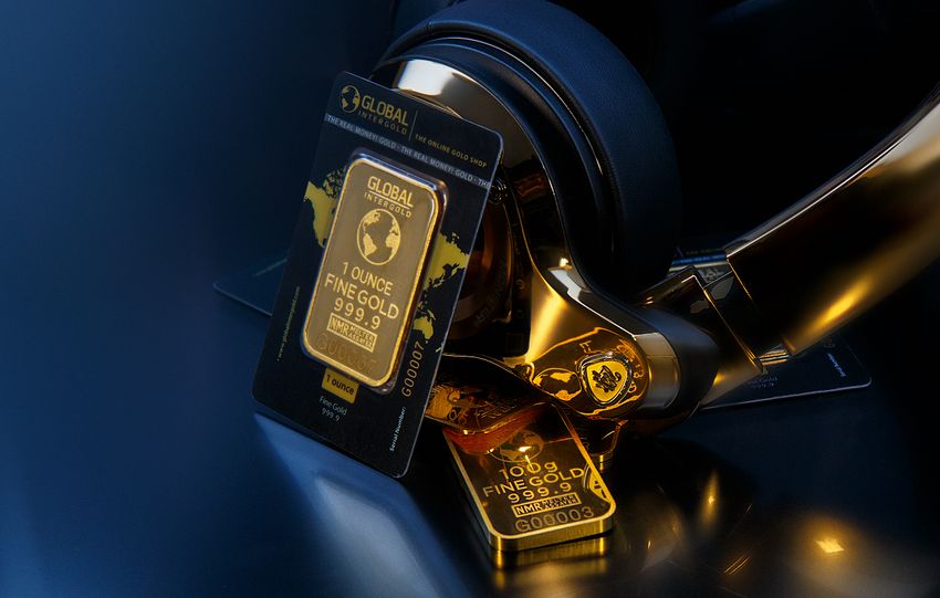 Elegant image of gold bars paired with sleek gold headphones, symbolizing wealth and luxury.