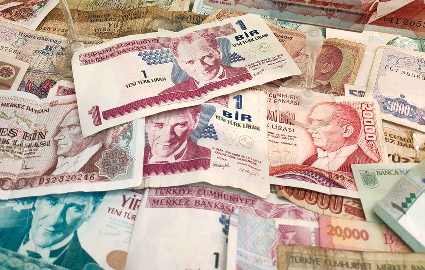 Turkish Lira banknotes of various denominations displayed, showcasing historical currency.