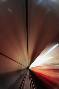 Abstract view of a subway tunnel with motion blur and light streaks.