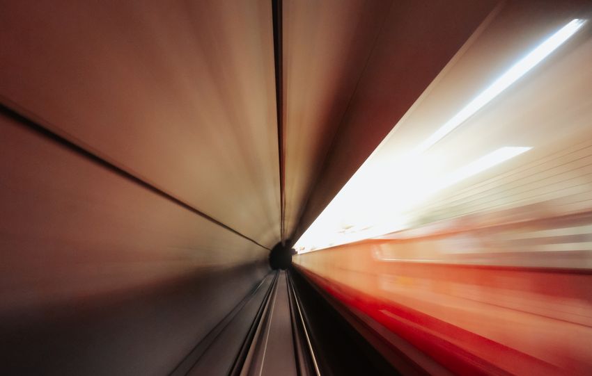 Abstract view of a subway tunnel with motion blur and light streaks.