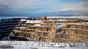 Aerial view of a snow-covered quarry in Bewerley, North Yorkshire, England during winter.