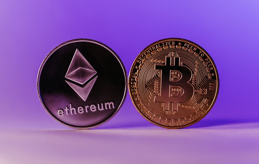 Close-up of Ethereum and Bitcoin coins symbolizing cryptocurrency and blockchain technology against a purple backdrop.