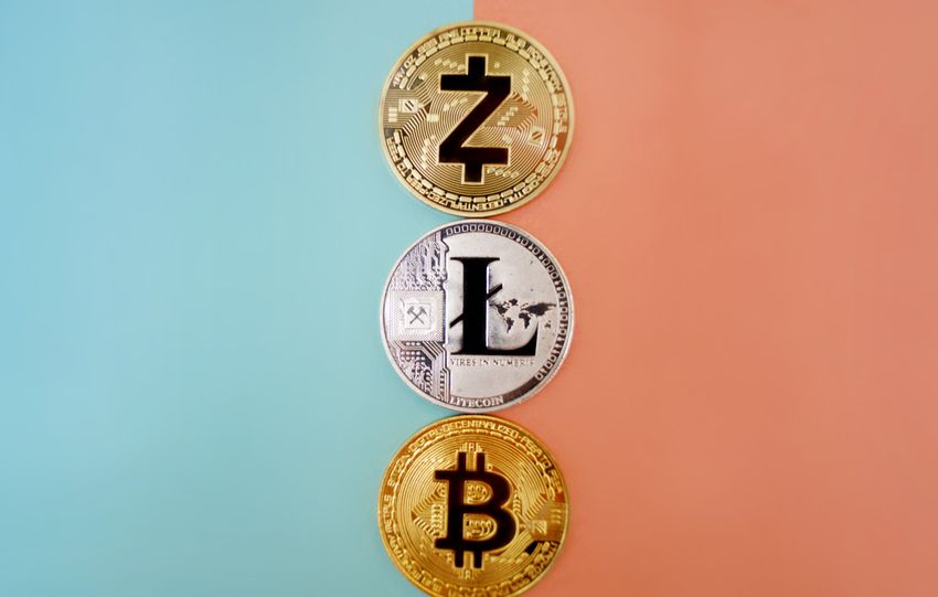 Colorful display of Zcash, Litecoin, and Bitcoin coins on gradient background.
