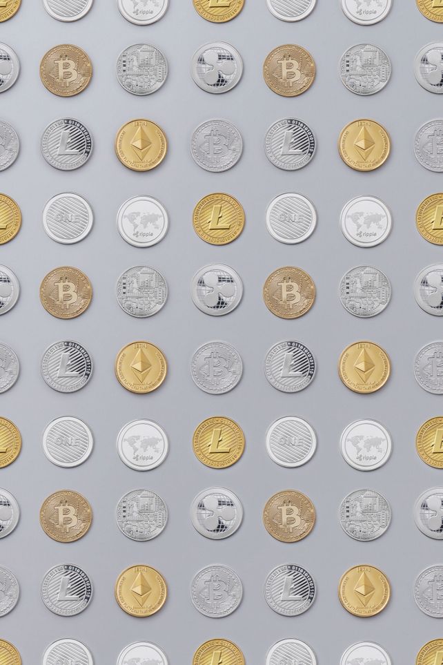 Flat lay of various cryptocurrency coins on white background, showcasing digital currency concept.