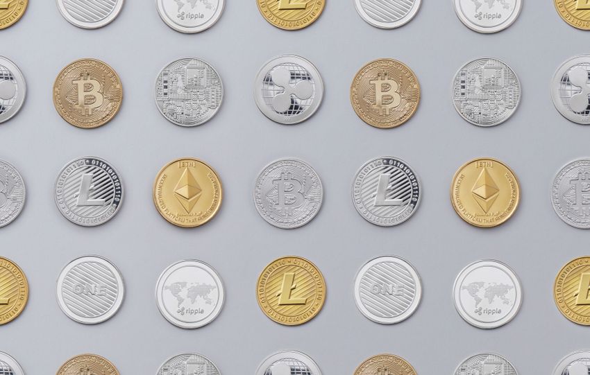 Flat lay of various cryptocurrency coins on white background, showcasing digital currency concept.