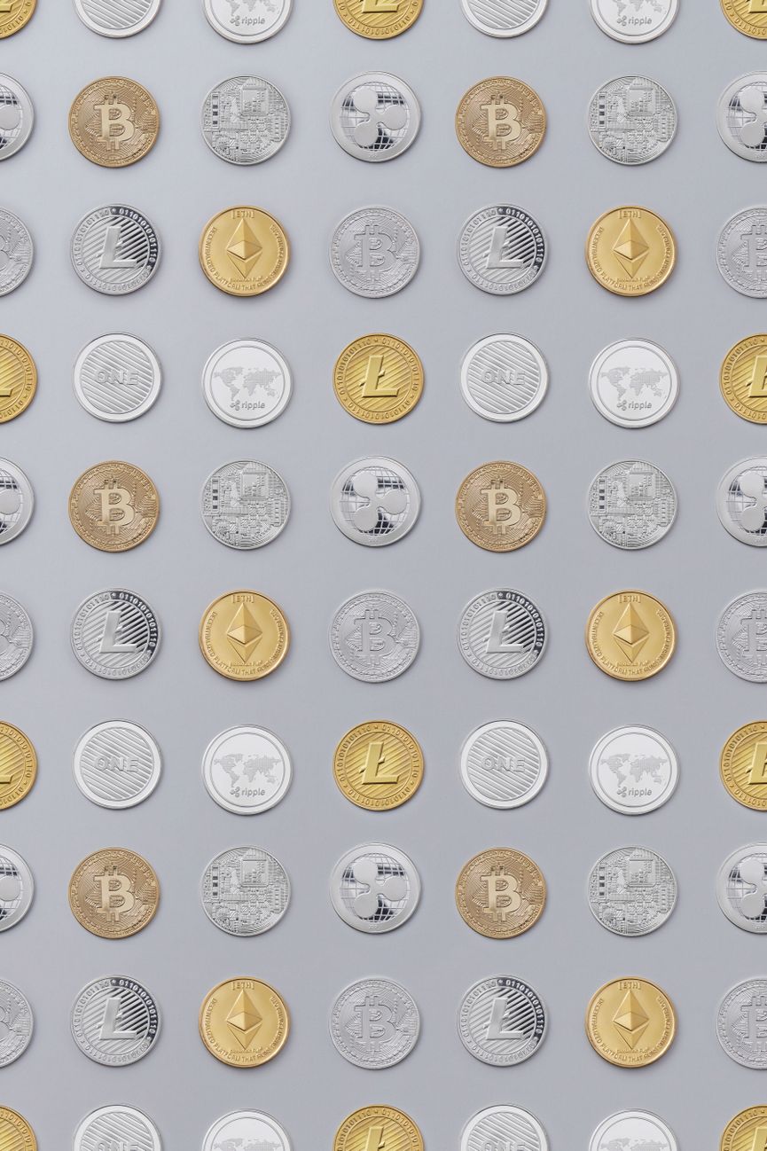 Flat lay of various cryptocurrency coins on white background, showcasing digital currency concept.