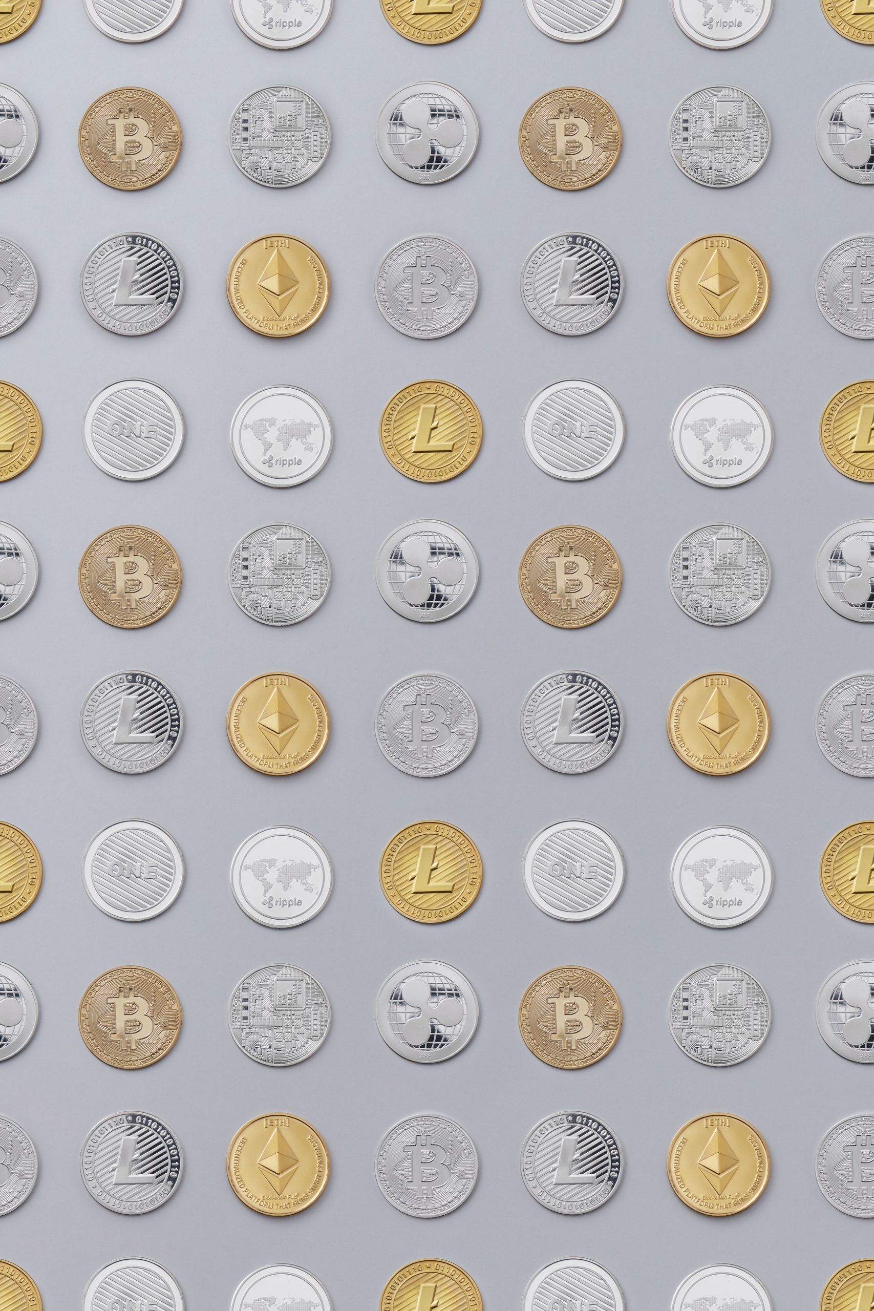 Flat lay of various cryptocurrency coins on white background, showcasing digital currency concept.