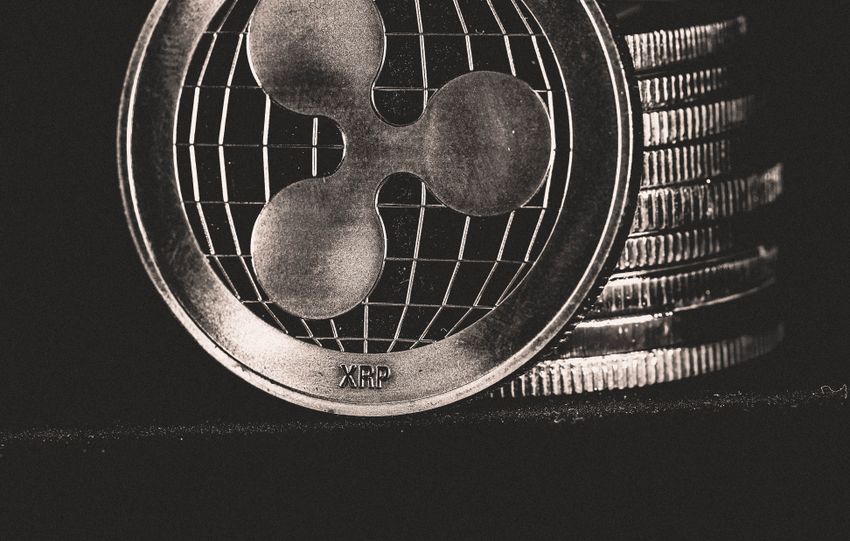 Monochrome image of Ripple coins stacked vertically, symbolizing digital currency.