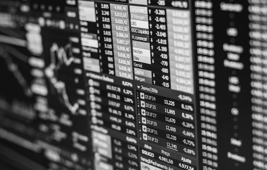 Monochrome image of stock market data on a screen, depicting financial information and trends.