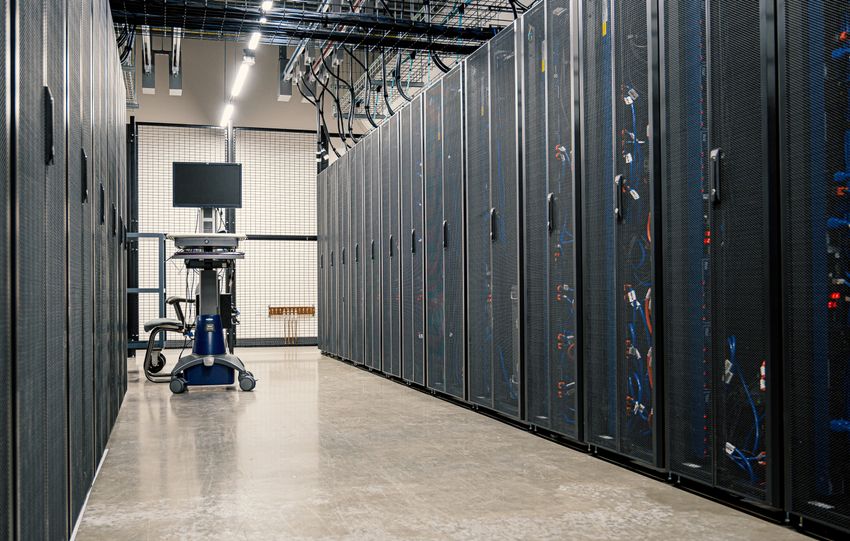 Steel framework cabinets housing servers networking devices and cables in contemporary equipped data center