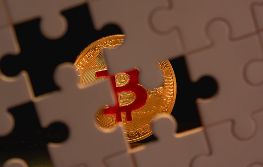 A bitcoin coin partially obscured by puzzle pieces, symbolizing the complexity and mystery of cryptocurrency.