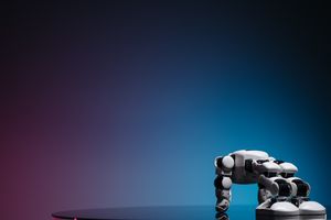 A close-up of a futuristic robot toy on a reflective surface against a gradient background.