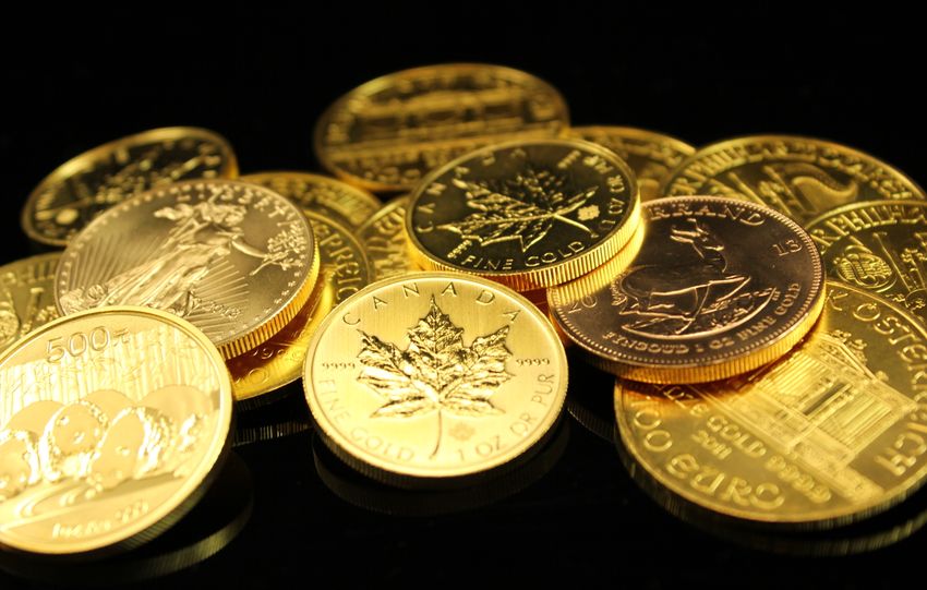 A collection of gold coins showcasing wealth and prosperity on a black background.