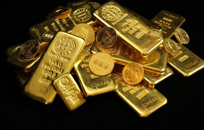 A collection of shining gold bars and coins symbolizing wealth and investment.