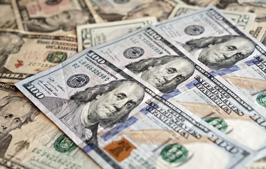 Close-up view of US currency highlighting hundred dollar bills, representing finance and economics.