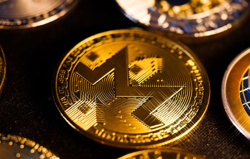Shiny gold Monero coin close-up, focusing on digital currency aesthetics and investment potential.
