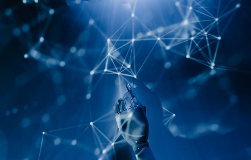 A robotic hand reaching into a digital network on a blue background, symbolizing AI technology.