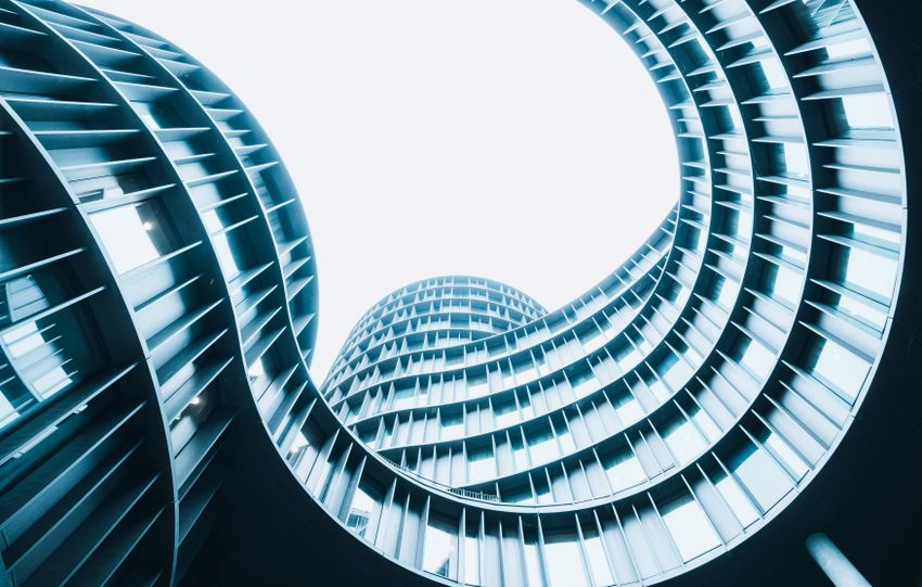 A striking low-angle shot of a modern spiral designed building showcasing urban architectural innovation.