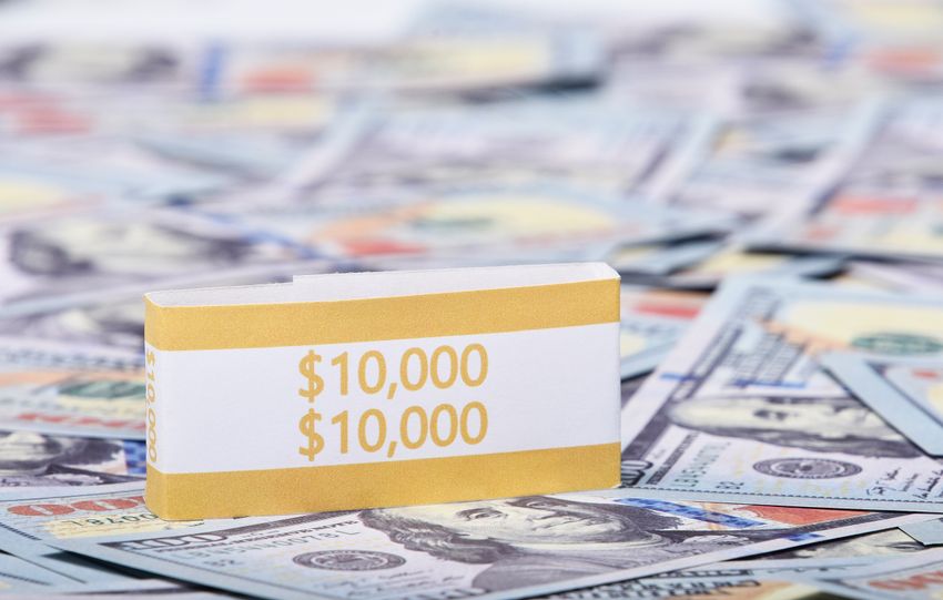 Close-up image of a stack of US dollars with a $10,000 band, symbolizing wealth and finance.