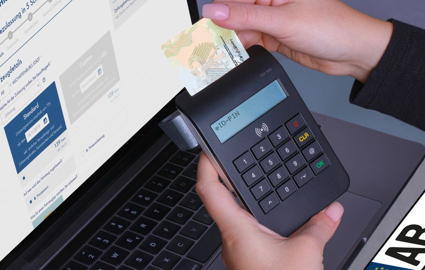 Close-up of a contactless payment using a card reader and laptop, highlighting digital security.