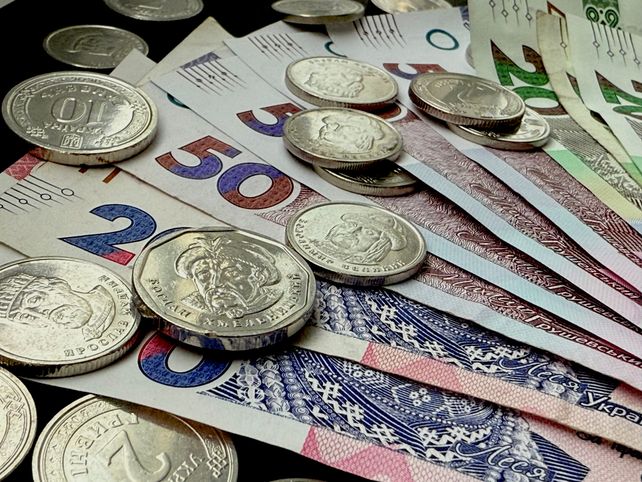 Close-up of various coins and banknotes from different countries, showcasing diversity in currency.