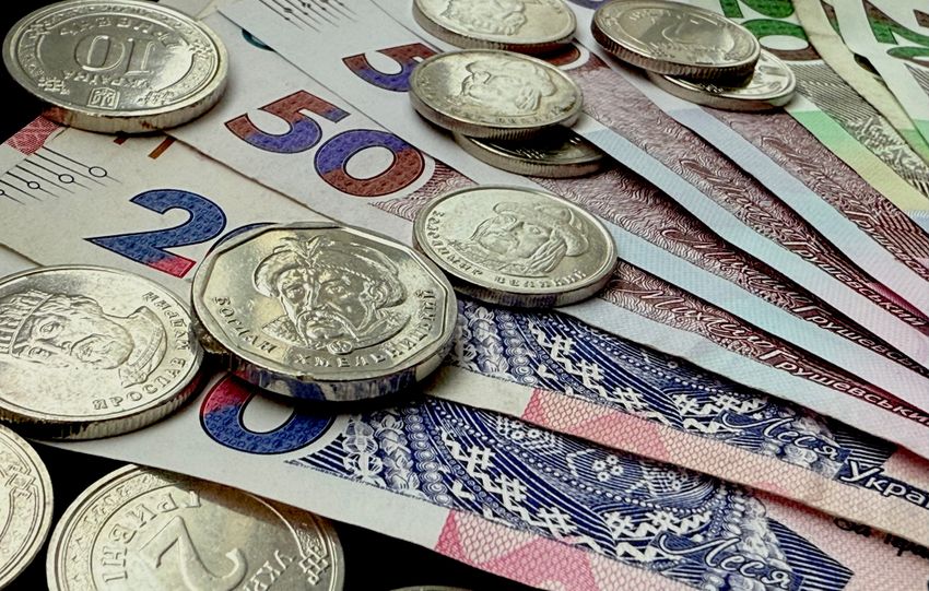 Close-up of various coins and banknotes from different countries, showcasing diversity in currency.