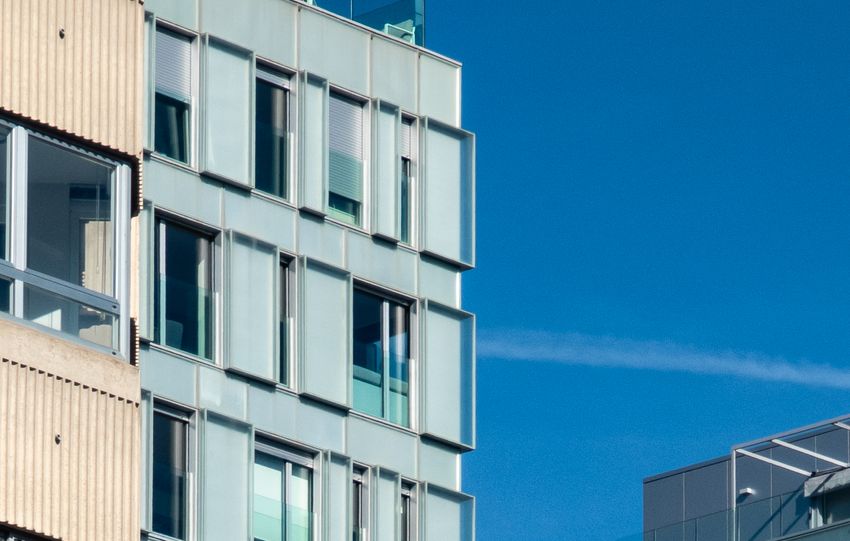 Contemporary urban architecture with modern buildings under a clear blue sky.